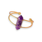 Ascendancy Gems Celestial Amethyst Bracelet with a double-terminated amethyst crystal wrapped in gold wire on a gold cuff.
