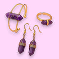 Ascendancy Gems Celestial Amethyst Collection: gold-tone bracelet, ring, and earrings with purple amethyst crystal points.
