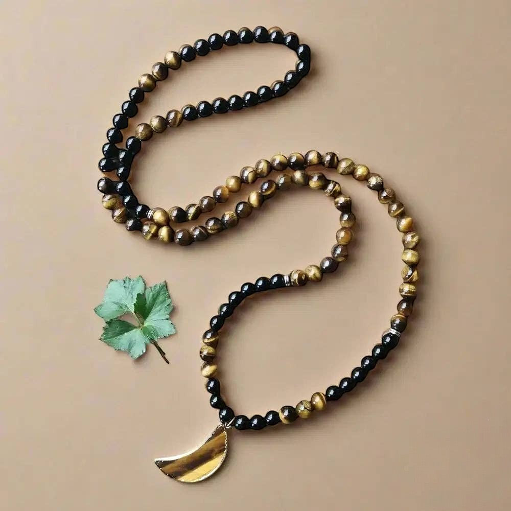Ascendancy Gems 108-bead mala necklace with black onyx, tiger eye stones, and a crescent moon pendant.