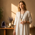 Ascendancy Gems mala necklace with black onyx and tiger eye beads and a crescent moon pendant worn by a woman.