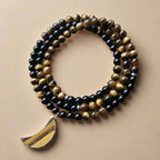 Ascendancy Gems 108-bead mala necklace with black onyx, tiger eye, and a gold-rimmed tiger eye moon pendant.