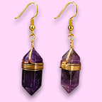 Ascendancy Gems Celestial Amethyst Earrings with gold wire wrap and gold hooks. Features faceted purple amethyst gemstones.