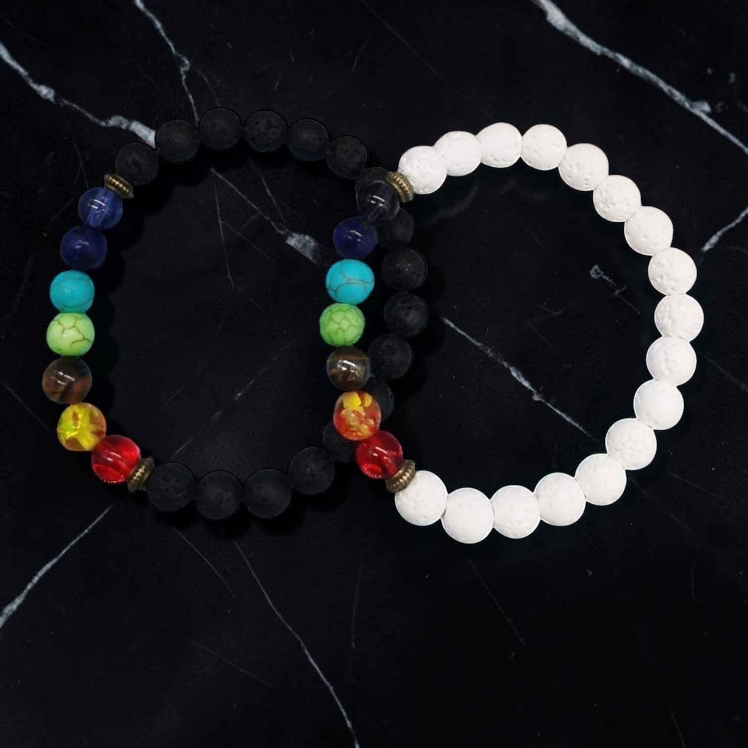 Ascendancy Gems Shakra Lava bead bracelets with black and white lava stones and colorful chakra beads.