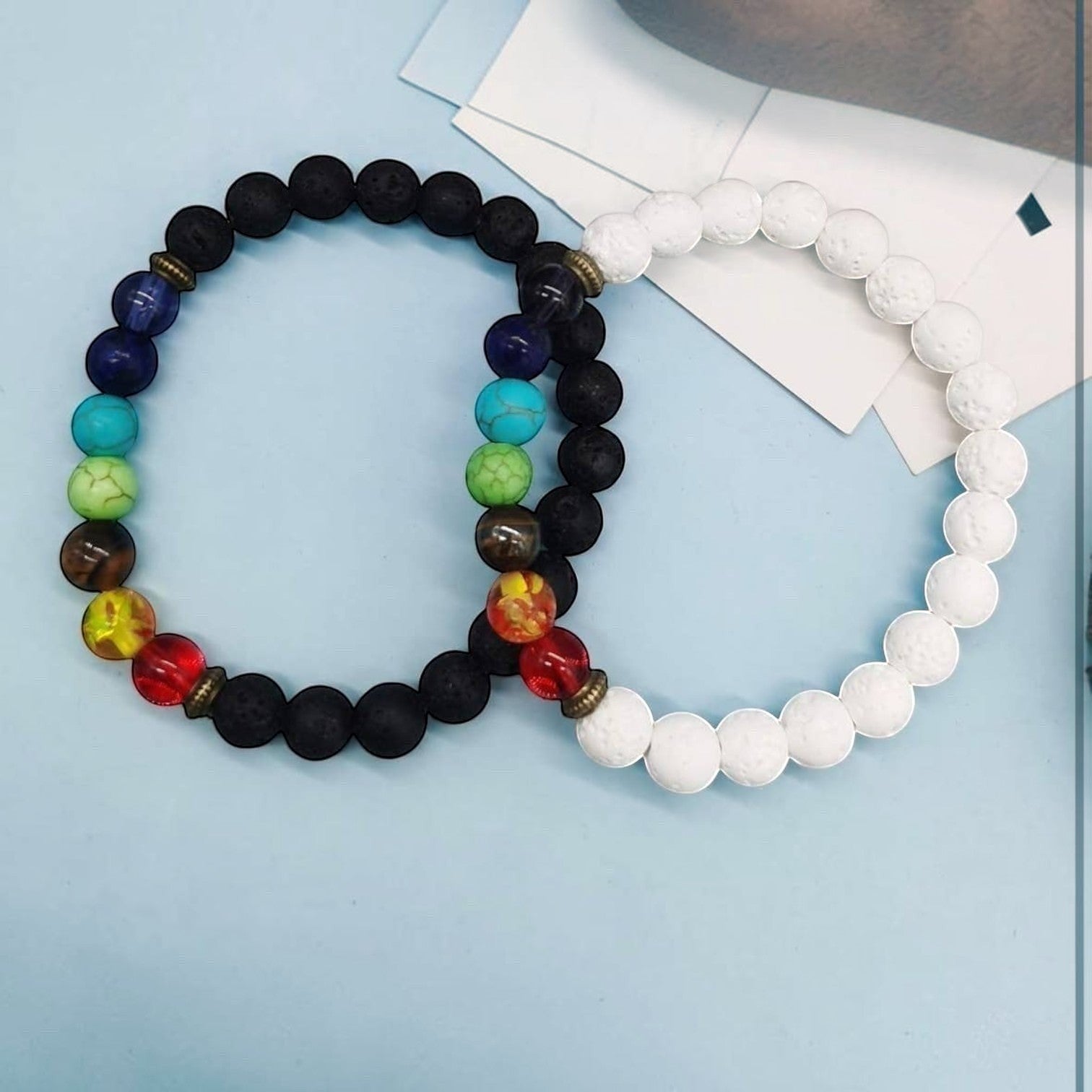 Ascendancy Gems Shakra Lava bead bracelets with black and white lava stones and colorful chakra beads.