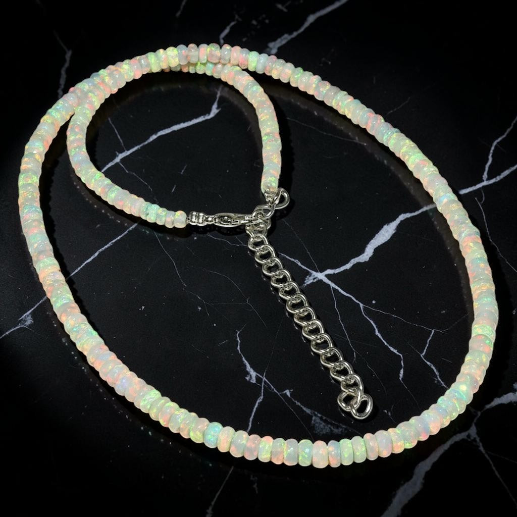 Ascendancy Gems handcrafted Ethiopian Welo fire opal bead necklace with rainbow play-of-color and adjustable chain.