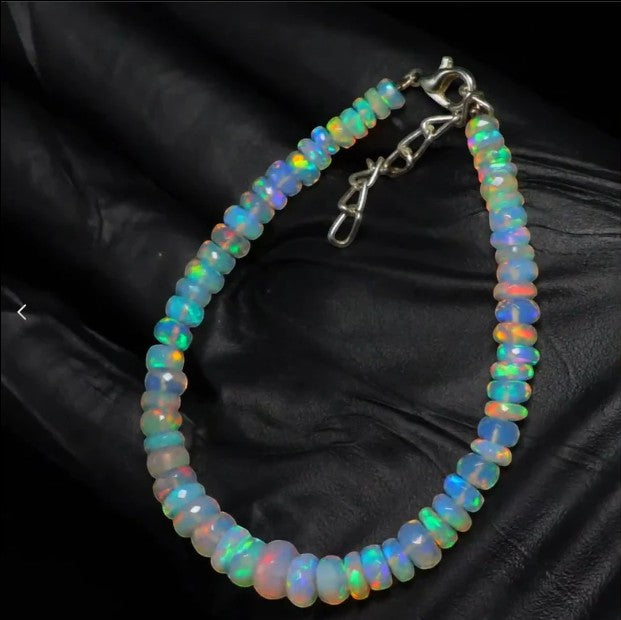 Ascendancy Gems handcrafted Ethiopian Welo opal bead bracelet featuring vibrant rainbow fire and adjustable clasp.