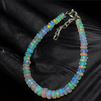 Ascendancy Gems handcrafted Ethiopian Welo opal bead bracelet featuring vibrant rainbow fire and adjustable clasp.