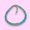 Ascendancy Gems handcrafted Ethiopian Welo opal bead bracelet with vibrant rainbow fire and adjustable metal clasp.