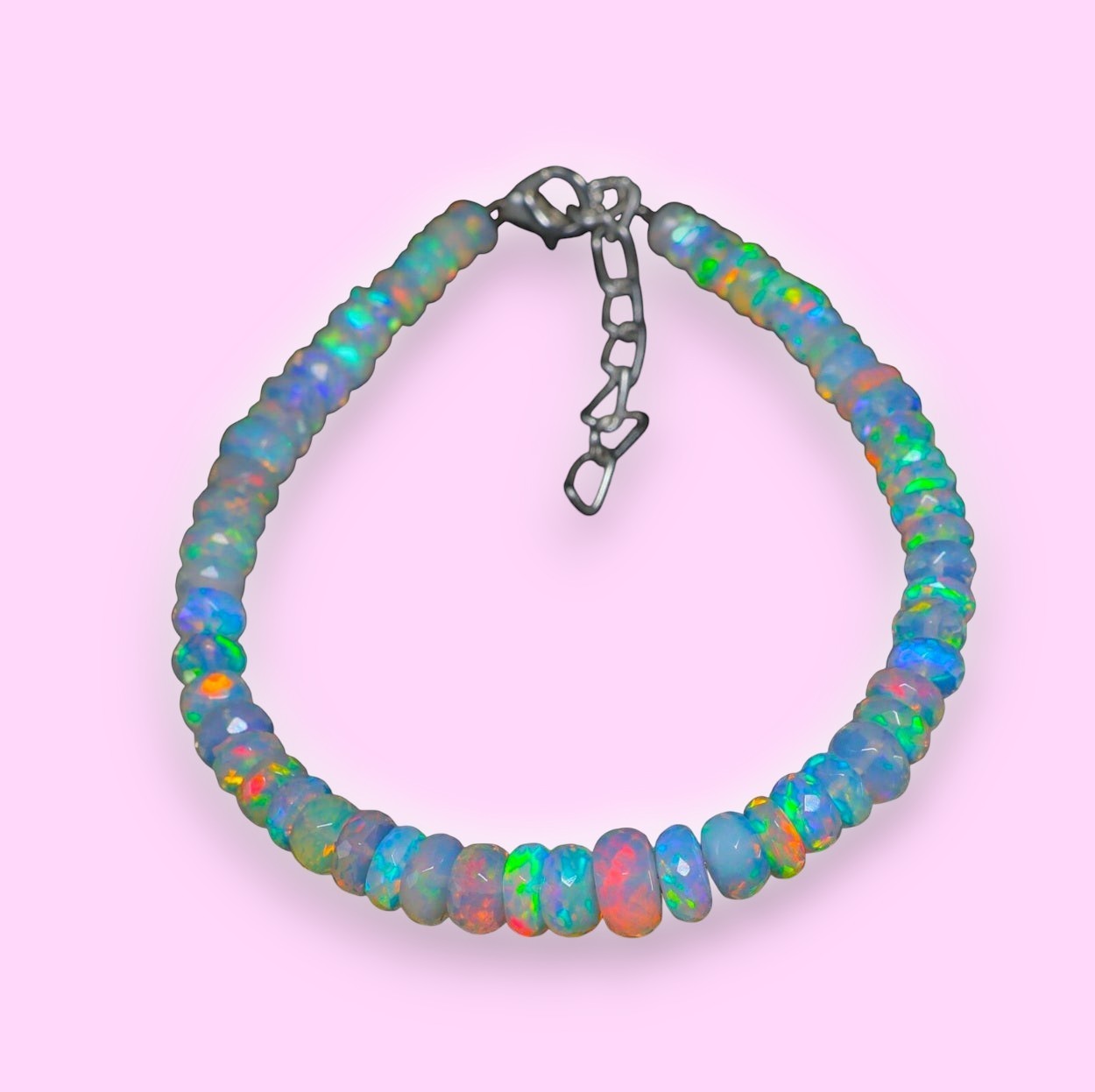 Ascendancy Gems handcrafted Ethiopian Welo opal bead bracelet with vibrant rainbow fire and adjustable metal clasp.
