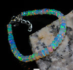 Ascendancy Gems handcrafted Ethiopian Welo opal bead bracelet featuring vibrant rainbow fire and adjustable clasp.