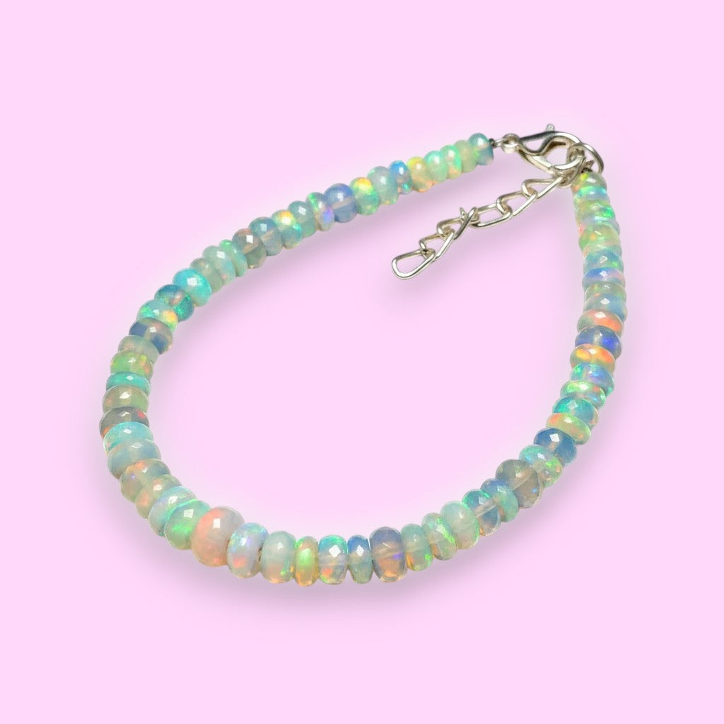 Ascendancy Gems handcrafted Ethiopian Welo opal bead bracelet with vibrant rainbow fire and adjustable silver clasp.