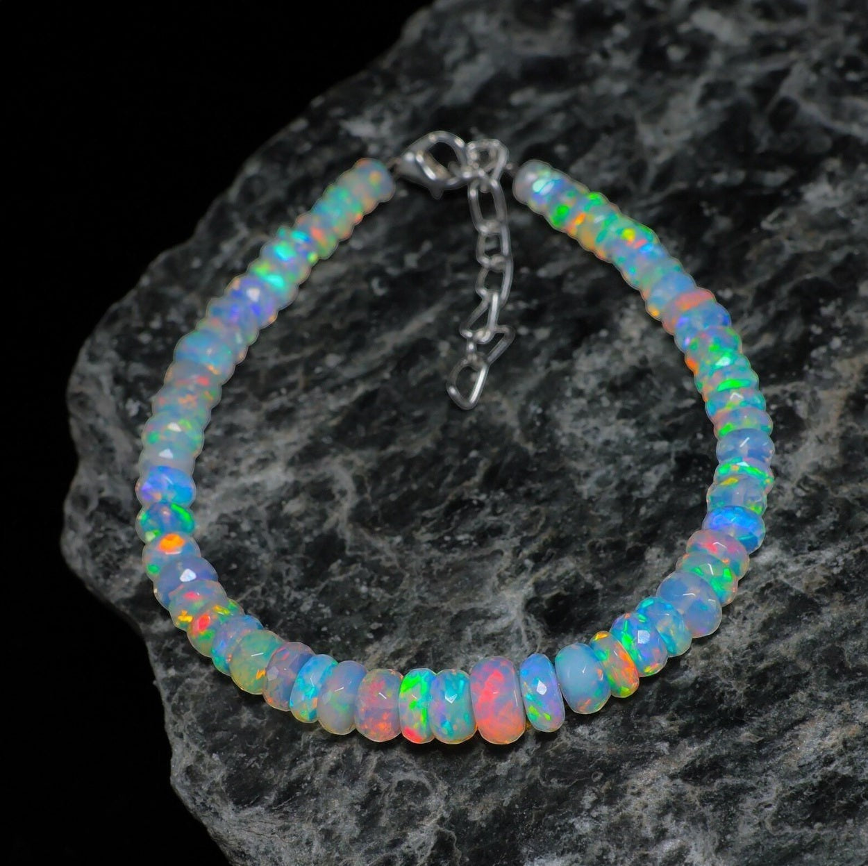 Ascendancy Gems handcrafted Ethiopian Welo opal bracelet with rainbow fire beads and adjustable silver clasp.