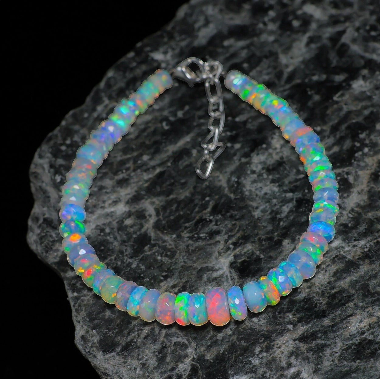 Ascendancy Gems handcrafted Ethiopian Welo opal bracelet with rainbow fire beads and adjustable silver clasp.