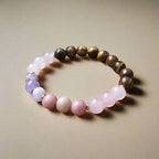 Ascendancy Gems handcrafted gemstone bracelet featuring Tiger Eye, Amethyst, Rose Quartz, and Rhodonite beads.