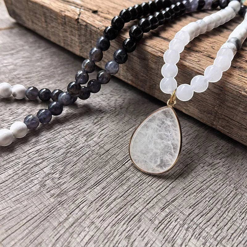 Ascendancy Gems Awakening Mala Set: 108-bead necklace & bracelet with white howlite, black onyx, and quartz teardrop pendant.