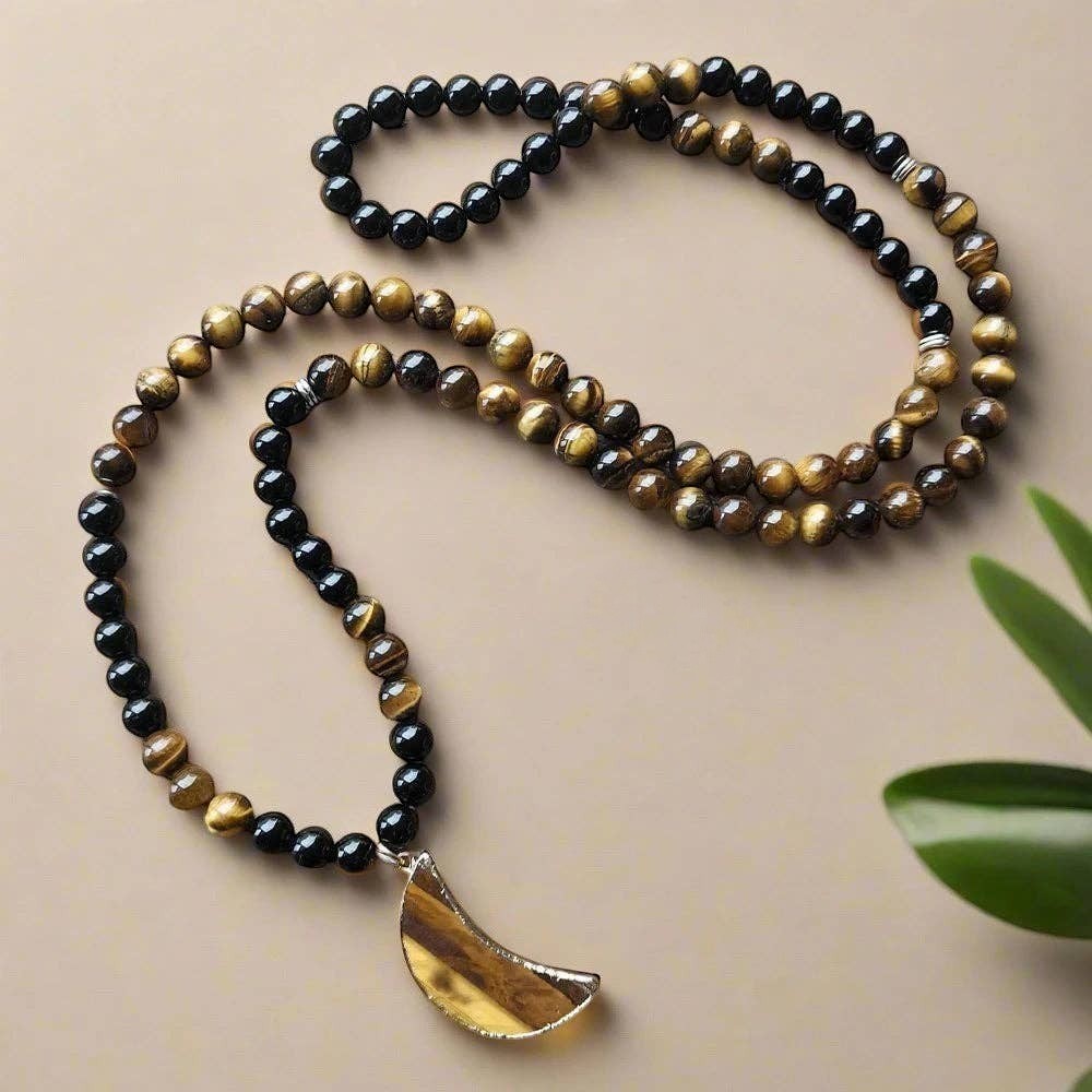 Ascendancy Gems mala necklace with black onyx and tiger eye beads featuring a crescent moon pendant for meditation.