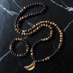 Ascendancy Gems mala necklace and bracelet set with black onyx, tiger eye beads, and a tiger eye moon pendant.
