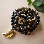 Ascendancy Gems mala necklace and bracelet set with black onyx and tiger eye beads and a crescent moon pendant.