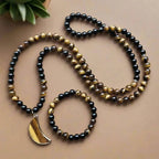 Ascendancy Gems mala necklace and bracelet set with black onyx and tiger eye beads and a tiger eye moon pendant.