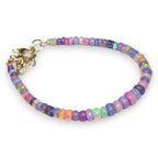 Ascendancy Gems one-of-a-kind purple smoked opal beaded bracelet with flashes of green, orange, red, and blue fire. 6 inches.