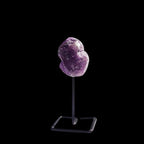 Ascendancy Gems raw amethyst crystal on a minimalist black metal stand, approx. 4 inches tall.