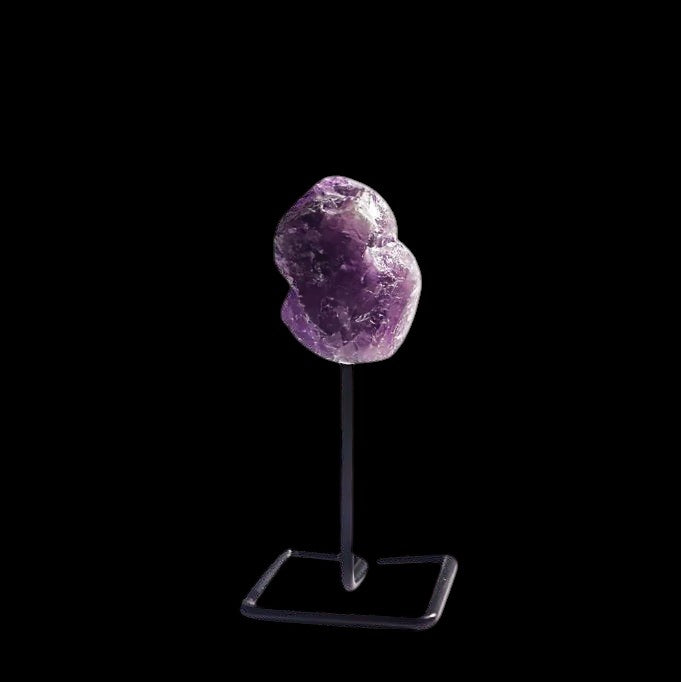 Ascendancy Gems raw amethyst crystal on a minimalist black metal stand, approx. 4 inches tall.