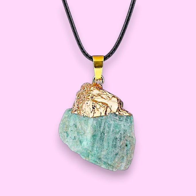 Ascendancy Gems raw aquamarine crystal pendant necklace with gold cap and black cord.