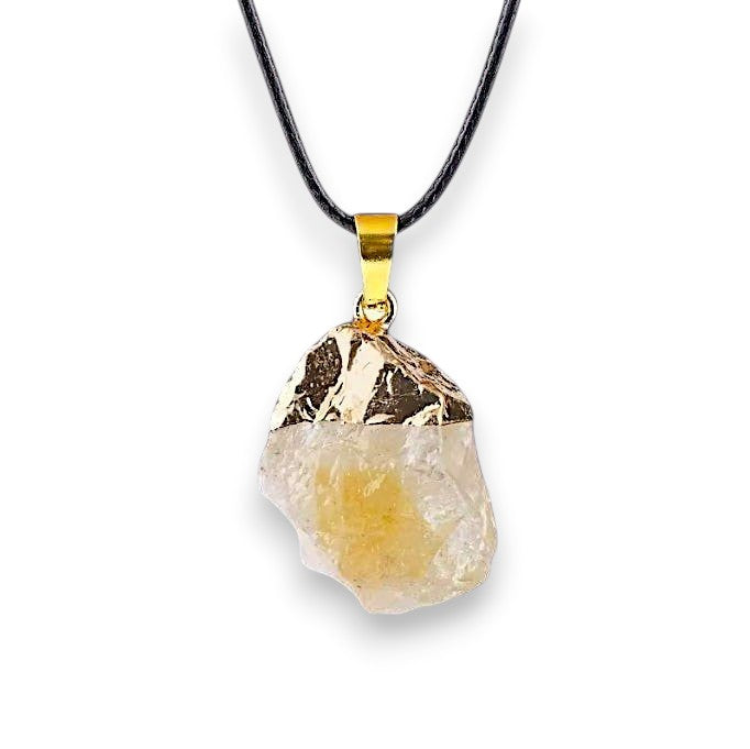 Ascendancy Gems raw crystal necklace with a pale yellow stone and gold cap on a black cord.