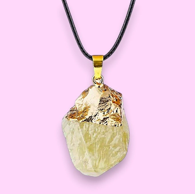 Ascendancy Gems raw light yellow crystal pendant necklace with gold cap and black cord.