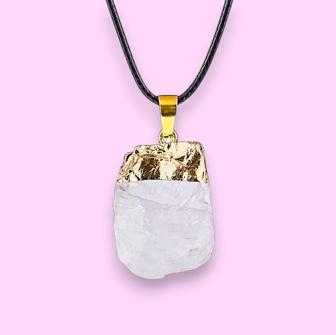 Ascendancy Gems raw clear quartz crystal pendant necklace with gold cap and black cord.