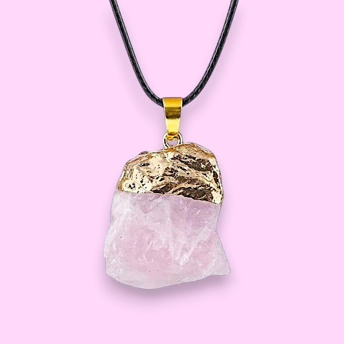 Ascendancy Gems raw rose quartz crystal necklace with gold cap and black cord. Natural, irregular shape.