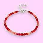 Ascendancy Gems handcrafted bracelet featuring faceted red Ethiopian Welo fire opal rondelle beads and silver clasp.