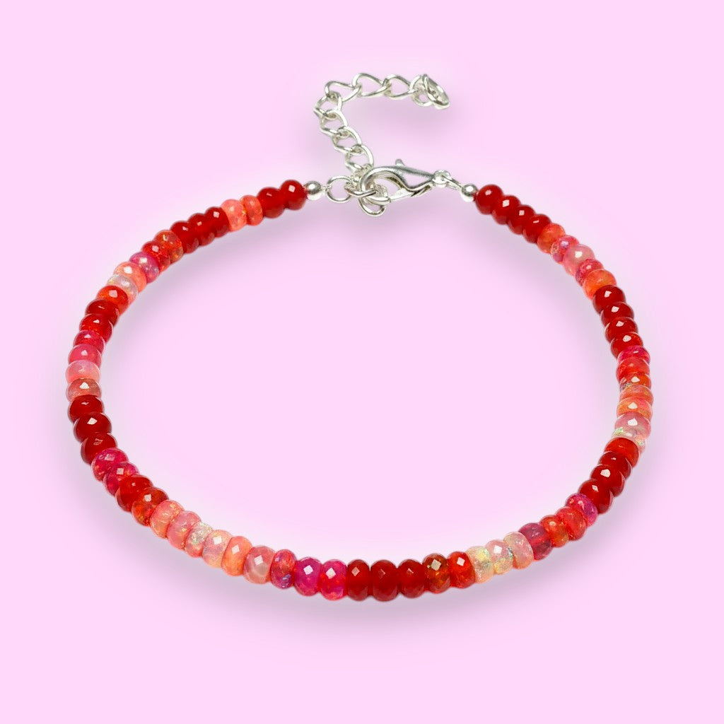 Ascendancy Gems handcrafted bracelet featuring faceted red Ethiopian Welo fire opal rondelle beads and silver clasp.
