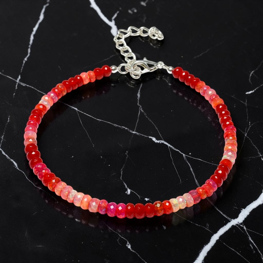 Ascendancy Gems handcrafted bracelet featuring faceted red Ethiopian Welo fire opal rondelle beads with silver clasp.