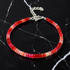 Ascendancy Gems handcrafted bracelet featuring faceted red Ethiopian Welo fire opal rondelle beads with silver clasp.