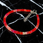 Ascendancy Gems handcrafted bracelet featuring faceted red Ethiopian Welo fire opal beads with a silver clasp.
