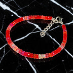 Ascendancy Gems handcrafted bracelet featuring faceted red Ethiopian Welo fire opal beads with a silver clasp.