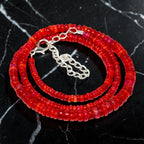 Ascendancy Gems handcrafted necklace featuring vibrant red Ethiopian Welo fire opal rondelle beads with silver clasp.