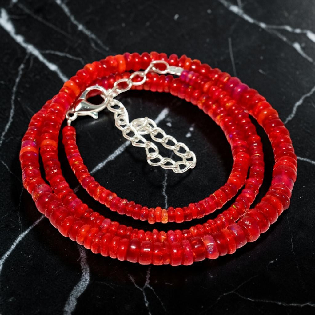 Ascendancy Gems handcrafted necklace featuring vibrant red Ethiopian Welo fire opal rondelle beads with silver clasp.