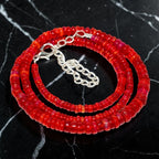 Ascendancy Gems handcrafted necklace featuring vibrant red Ethiopian Welo fire opal rondelle beads with silver clasp.