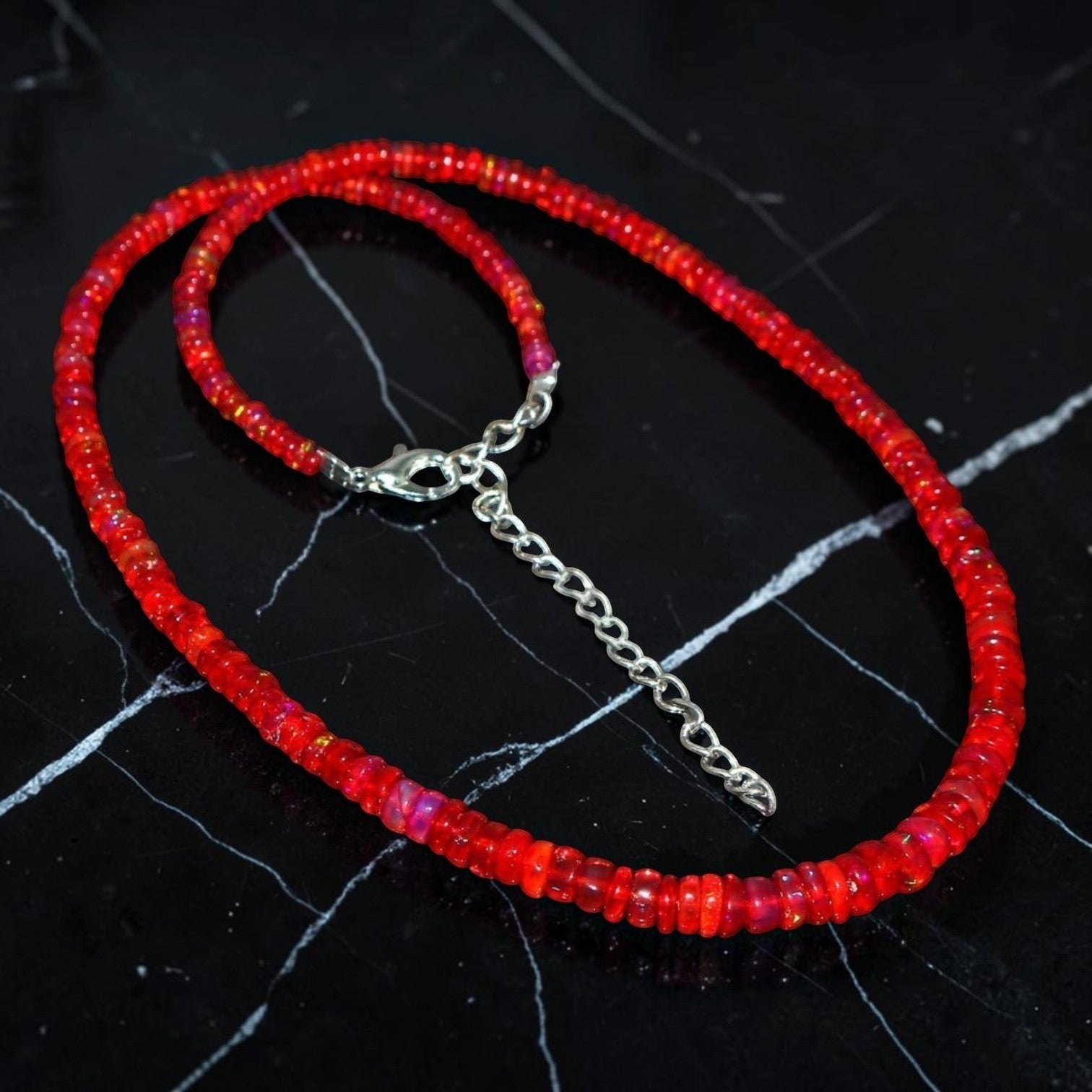 Ascendancy Gems handcrafted necklace featuring vibrant red Ethiopian Welo fire opal rondelle beads with silver clasp.