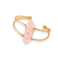 Ascendancy Gems Celestial Rose Quartz Bracelet with a raw pink quartz crystal wrapped in gold wire on a gold cuff.